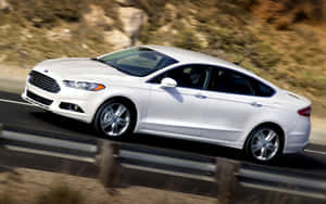 Sleek And Stylish Ford Fusion On A Beautiful Scenic Road Wallpaper