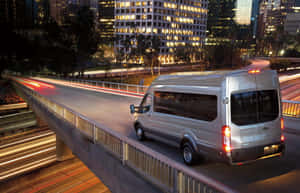 Sleek And Stylish Ford Transit On The Road Wallpaper