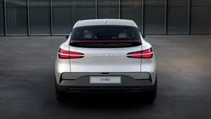 Sleek And Stylish Genesis Gv60 Electric Suv On A Scenic Road Wallpaper