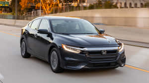 Sleek And Stylish Honda Insight On Scenic Road Wallpaper