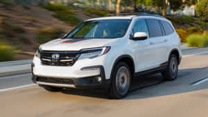 Sleek And Stylish Honda Pilot On The Road Wallpaper