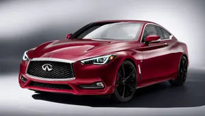 Sleek And Stylish Infiniti Q60 In Motion Wallpaper