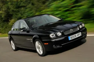 Sleek And Stylish Jaguar X-type In Action Wallpaper