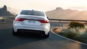 Sleek And Stylish Jaguar Xf Under The Lights Wallpaper