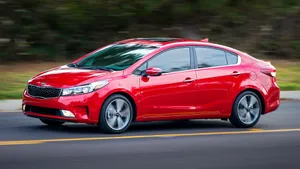 Sleek And Stylish Kia Forte Parked Outdoor Wallpaper