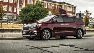 Sleek And Stylish Kia Sedona Minivan On The Open Road Wallpaper