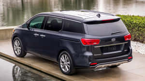 Sleek And Stylish Kia Sedona Minivan On The Road Wallpaper