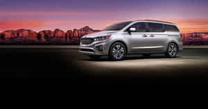 Sleek And Stylish Kia Sedona On The Road Wallpaper