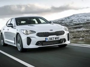 Sleek And Stylish Kia Stinger On The Open Road Wallpaper