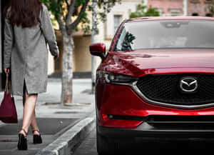 Sleek And Stylish Mazda Cx-5 Driving On The Open Road Wallpaper