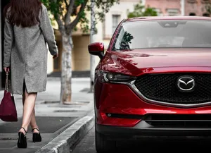 Sleek And Stylish Mazda Cx-5 Driving On The Open Road Wallpaper