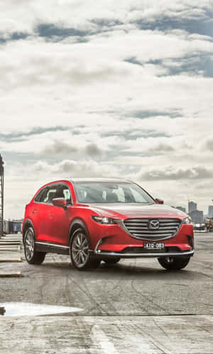 Sleek And Stylish Mazda Cx-9 On The Road Wallpaper