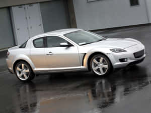 Sleek And Stylish Mazda Rx-8 On The Road Wallpaper