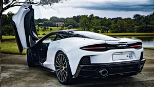 Sleek And Stylish Mclaren Gt On The Road Wallpaper