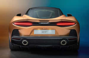 Sleek And Stylish Mclaren Gt On The Road Wallpaper