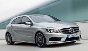 Sleek And Stylish Mercedes Benz A-class On The Road Wallpaper