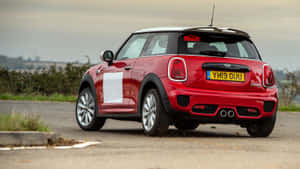 Sleek And Stylish Mini Cooper S On Open Road Wallpaper