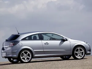 Sleek And Stylish Opel Astra Driving On The Open Road. Wallpaper