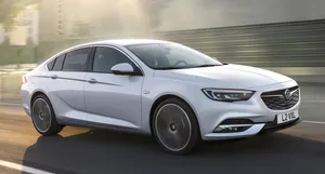 Sleek And Stylish Opel Insignia In Motion Wallpaper