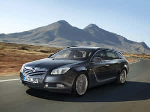 Sleek And Stylish Opel Insignia On The Road Wallpaper