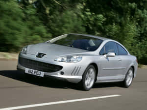 Sleek And Stylish Peugeot 407 In Full Speed Wallpaper