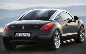 Sleek And Stylish Peugeot Rcz On The Road Wallpaper