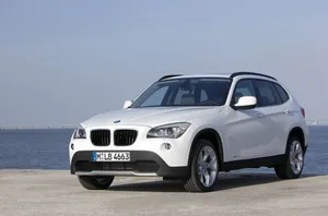 Sleek And Stylish: The Bmw X1 In Motion Wallpaper