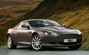 Sleek Aston Martin Db9 On The Open Road Wallpaper