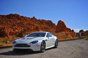 Sleek Aston Martin V12 Vantage In Motion Wallpaper