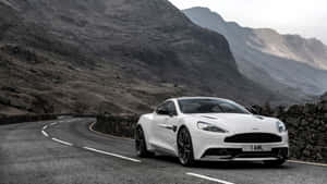 Sleek Aston Martin Vanquish In A Desert Landscape Wallpaper