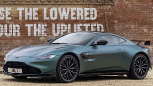 Sleek Aston Martin Vantage Cruising On An Open Road Wallpaper