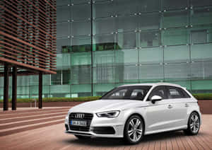 Sleek Audi A3 Cruising Through The City Streets Wallpaper