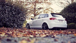 Sleek Audi A3 On Scenic Hilly Road Wallpaper