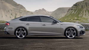 Sleek Audi A5 Sports Coupe On Urban Road Wallpaper