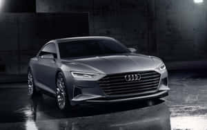 Sleek Audi A6 Cruising Down An Urban Road Wallpaper