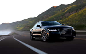 Sleek Audi A6 On An Empty Road Wallpaper