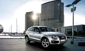 Sleek Audi Q5 Cruising On A Smooth Highway Wallpaper