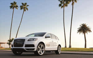 Sleek Audi Q7 Cruising On The Open Road Wallpaper