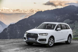 Sleek Audi Q7 In Striking Nighttime Setting Wallpaper