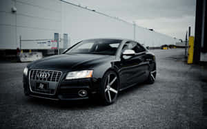 Sleek Audi S5 On A Picturesque Road Wallpaper