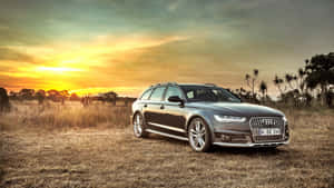 Sleek Audi S6 In Exhilarating Speed Wallpaper