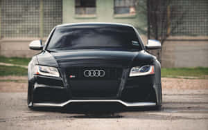 Sleek Audi S6 In Motion On A Picturesque Urban Street Wallpaper