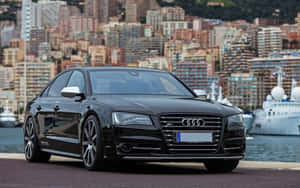 Sleek Audi S8 Driving On An Open Road Wallpaper