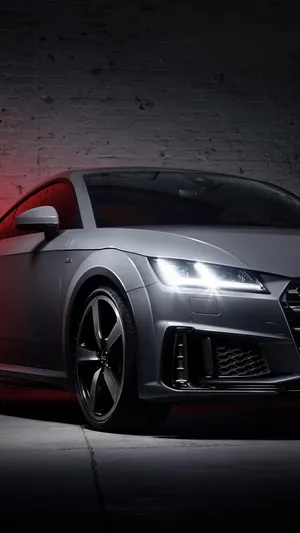 Sleek Audi Tt Rs Racing On The Road Wallpaper