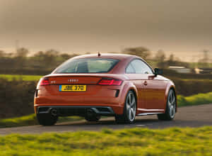 Sleek Audi Tt Sports Car On A Scenic Route Wallpaper