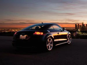 Sleek Audi Tt Sports Car On The Open Road Wallpaper