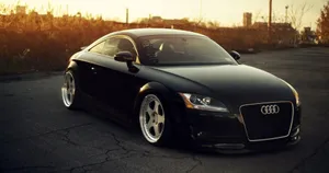 Sleek Audi Tt Sportscar On A Scenic Road Wallpaper