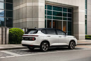 Sleek Baojun Driving On A Picturesque Road Wallpaper