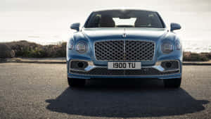 Sleek Bentley Flying Spur Cruising In The City Wallpaper