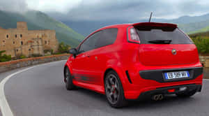 Sleek Black Abarth Racing Car On The Track Wallpaper